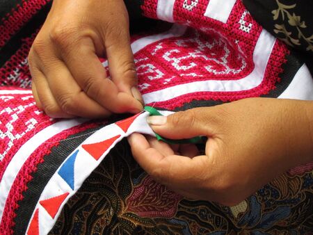 Hmong lady making traditional fabric