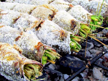 Herb stuffed fish on a grill in Bangkokの写真素材