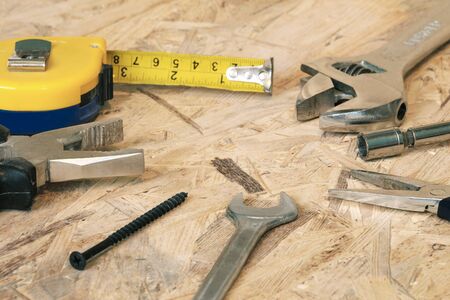 The working tools for construction and repair of house: tape measure (yardstick), wrench,...