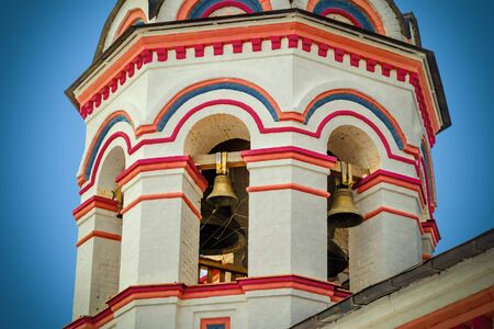 Architecture and exterior bell tower of old orthodox church. Belfry and tier ringing. Masonry temple bell tower. Photo with vignetting effect.の写真素材