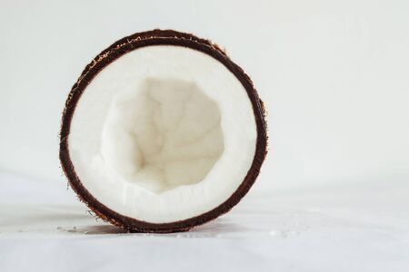 Cross section of coconut half on a soft white glossy surfaceの写真素材