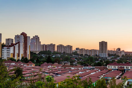 BELGOROD, RUSSIA - SEPTEMBER 10, 2016: Neighborhood of low-rise residential buildings with multi-storey buildings on a slope. Old street market "Salut". Evening skyline. Cityscape Belgorod, Russia.のeditorial素材