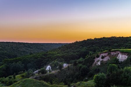 Sunset over the forest on the chalk hillsの写真素材