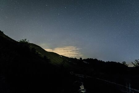 Starry night over the white chalky hills. Night background.