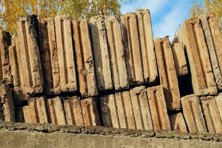 Dismantled reinforced concrete wall panels stored in tiers at the construction siteの写真素材