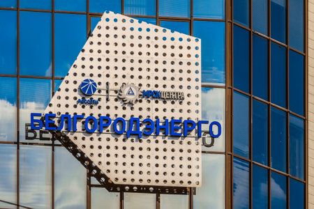 Belgorod, Russia - September 29, 2017: Emblem and logos close-up on glass mirror facade of building Belgorodenergo. Interregional Distribution Grid Company of the Center (IDGC / MRSK of Center) is a Russian energy company engaged in the transmission of elのeditorial素材