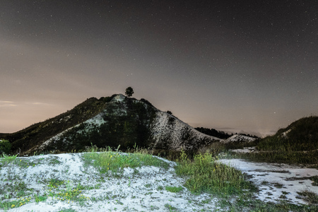 Dark night sky over the high chalk hill. Night natural landscape. Belgorod region, Russia.の写真素材