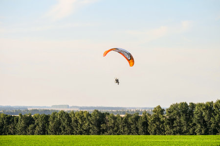 Prokhorovka, Belgorod region, Russia -August 06, 2017: Flight on motor glider over the tops of green...