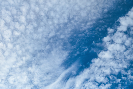 Beautiful clouds on a dark blue sky. Heavenly background. Universal template for background...