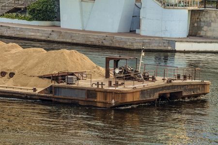 River cargo ferry carrying sandの写真素材