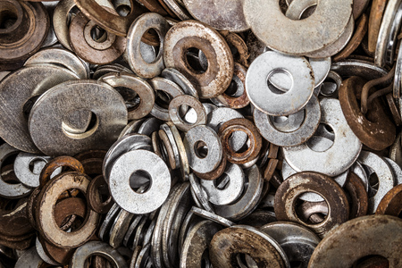 Metal washers in set. Spent fasteners background.の写真素材