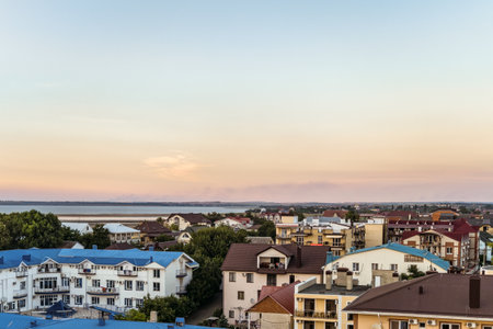 Krasnodar region, Anapa district, Vityazevo, Russia - July 14, 2018: Tourist town with hotels near central beach promenade of the Black Sea resort. Vityazevsky water estuary on the horizon.のeditorial素材