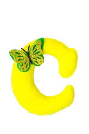 Handmade yellow letter C made of felt. Childrens alphabet C with small butterfly.の写真素材