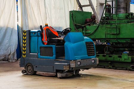 Floor sweeper and washer scrubber drier car in an industrial building engineering workshopの写真素材