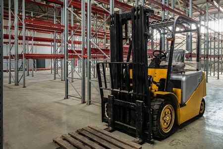 Compact forklift truck in a industrial warehouse buildingの写真素材