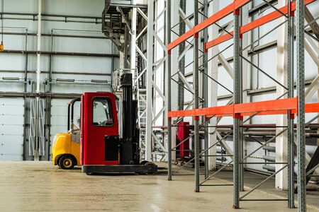 Forklift trucks in a industrial warehouse buildingの写真素材