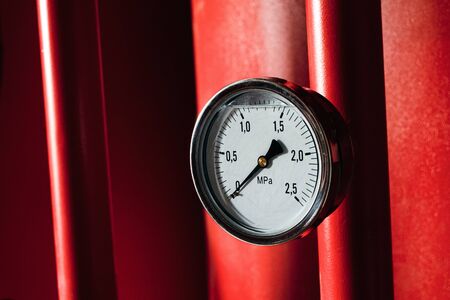 Pressure gauge on a red tubes. Industrial fire extinguishing system manometer.の写真素材