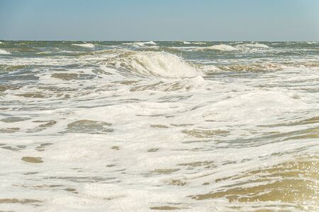 Powerful sea wave with foam. Tidal water surf. Seascape.