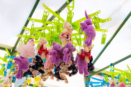 Hanging plush toys as small prize on mass event and festival or street entertainment gamesの写真素材