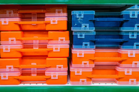 Plastic tool boxes on store shelves. Stack of organizers.の写真素材