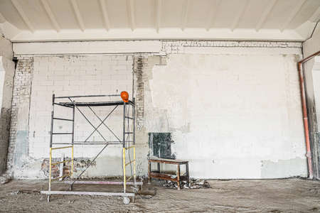 Metal construction tower scaffolding near the wall to be putty and paintedの写真素材