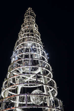 Christmas decoration construction. Steel frame with silvery mirror balls and garland for Illumination.の写真素材
