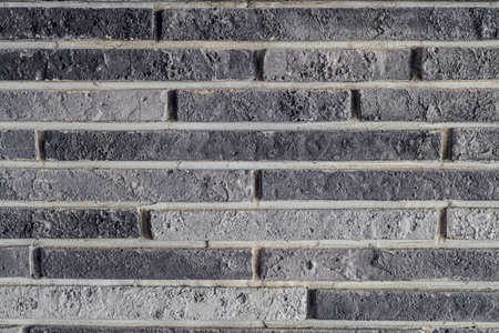 Facing decorative gray brick on wall close-up. Gypsum facing tile for interior decoration inside...