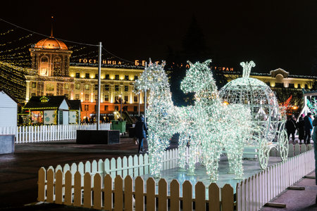 Belgorod, Russia - January 05, 2021: LED light horses with a carriage decoration composition in New Year's Cathedral Square Belgorod city.のeditorial素材