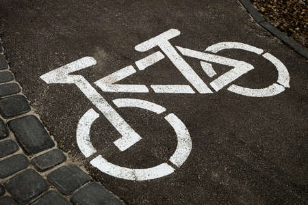 Bicycle path sign on dark asphaltの写真素材