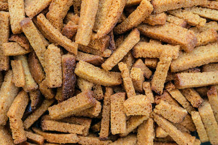 Salted rye bread croutons with spices close-up. Crispy bread sticks. Salty snack.の写真素材