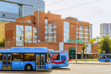 Moscow, Russia - July 21, 2021: Hotel Okhotnik (Hunter) on Kronstadt Boulevard in Moscow. Blue city buses on road.のeditorial素材