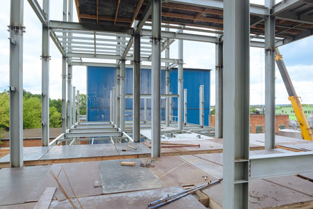 Construction of a metal frame multi-story industrial building. Floor beams.