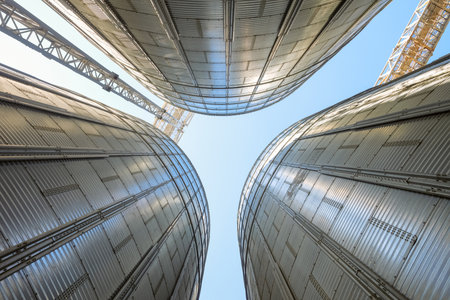 Silo Grain bins view from bottom to top. Grain dryer complex. Granary with loading tower.の写真素材