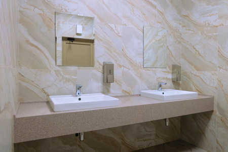 Public washroom. Two washbasins in the restroom.