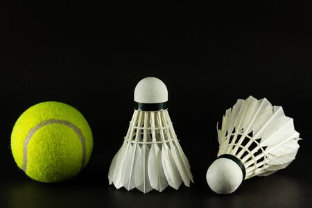 a tennis ball and two shuttlecock which always use with their racket when play の写真素材