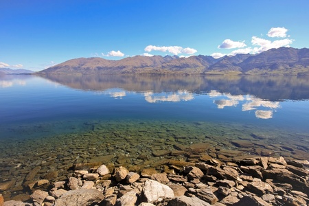 Hill and cloud reflections in a lake, New Zealand South Island.の写真素材