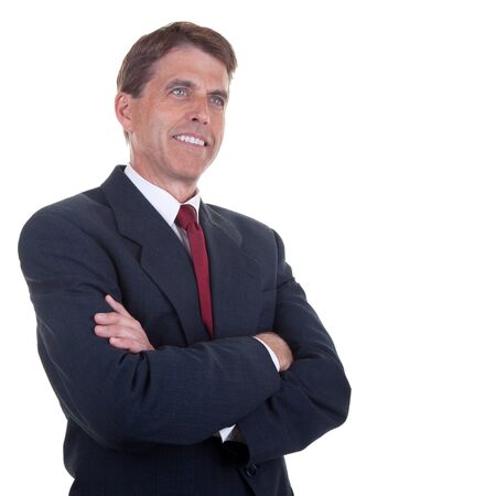 Attractive businessman with arms crossed, smiling and looking into space.の写真素材