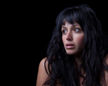 Dramatic portrait of a beautiful woman with Rembrandt lighting.の写真素材