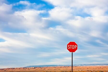 Stop Sign against a Dramatic Sky in the Desert の写真素材