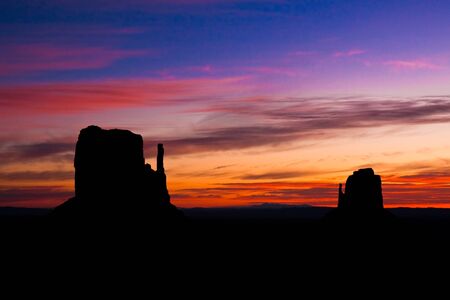 The East and West Mittens at sunrise in Monument Valley Tribal Park, Arizona の写真素材