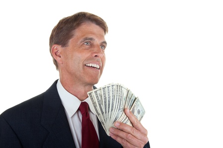 Happy business man looking up while fanning himself with newly earned bills.の写真素材