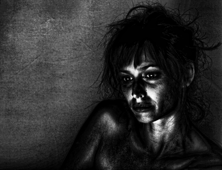 Artistic portrait of a sad woman in dramatic lighting.の写真素材