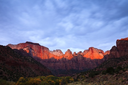 Sun rays hitting the top of Towers of the Virgin in Zion Canyon National Park, Utah.の写真素材