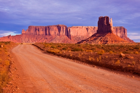 Road between the buttes of Monument Valley Navajo Tribal Park, Arizona.の写真素材
