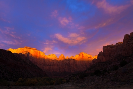 The sun kisses the top of the Towers of the Virgin at Zion Canyon National Park, Utah.の写真素材