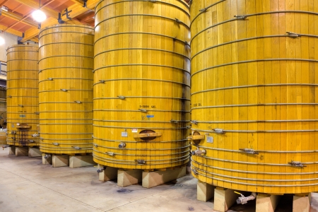 Large wooden casks in a California winery cellar.