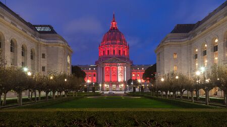 Night time panorama of San Francisco City Hall illuminated by red light.の写真素材