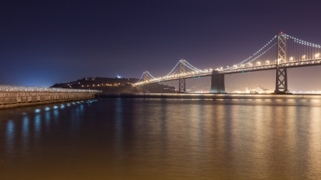 Night view of Bay Bridge and a pier in San Francisco.の写真素材