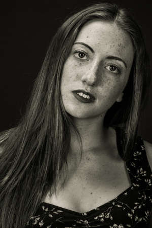 Portrait of a sad looking freckled womanの写真素材