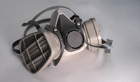 Chemical protection mask on a white background. It has two filters. Gray colour. An environmentally friendly protection solution during infection COVID 19.の写真素材